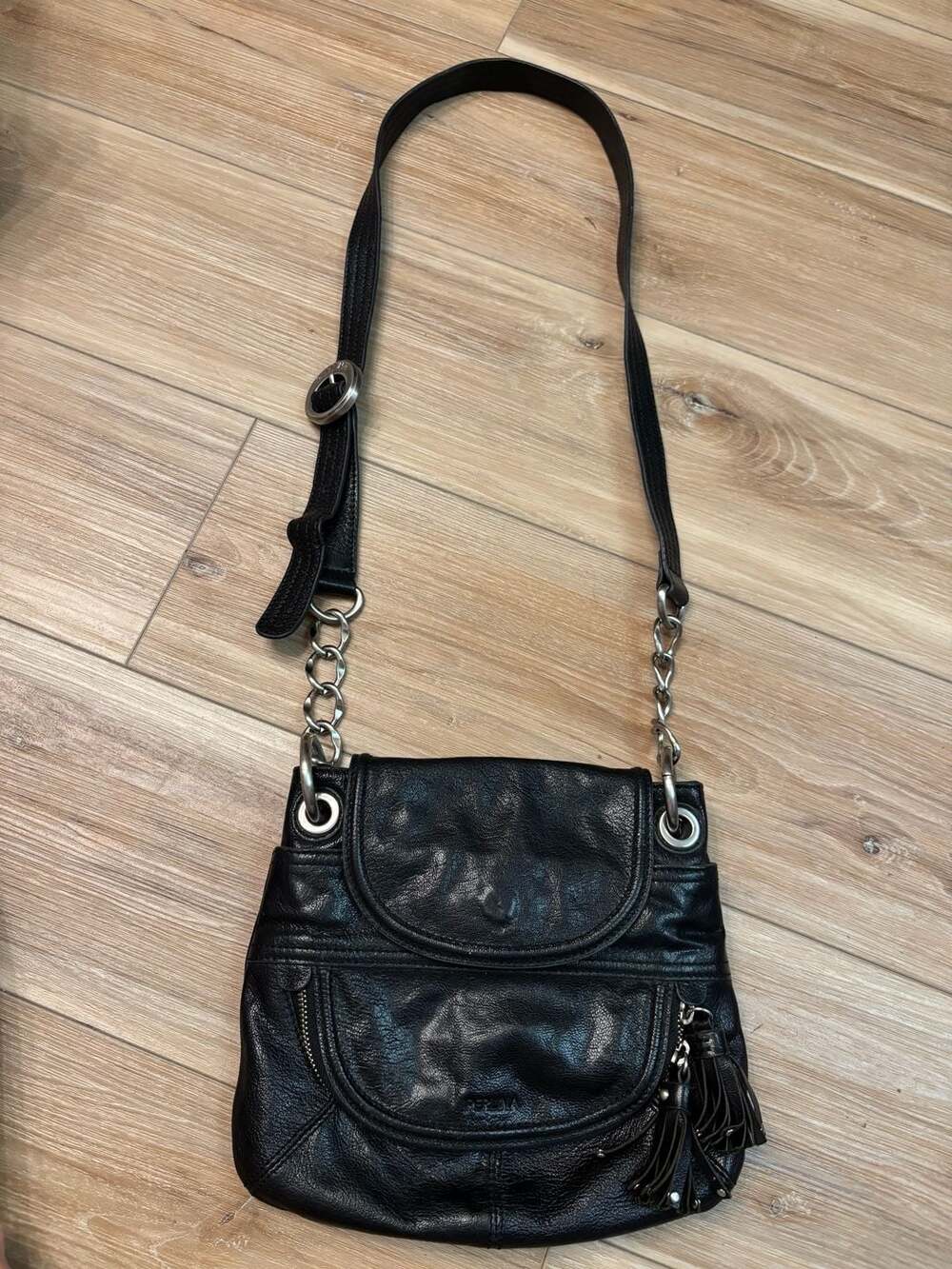 Perlina Black Pebbled Leather Crossbody Bag with Chain Strap and Tassel